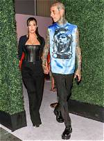 Travis Barker Kisses Kourtney Kardashian’s Foot While Wearing Matching Pjs: ‘All I Want for Christmas’